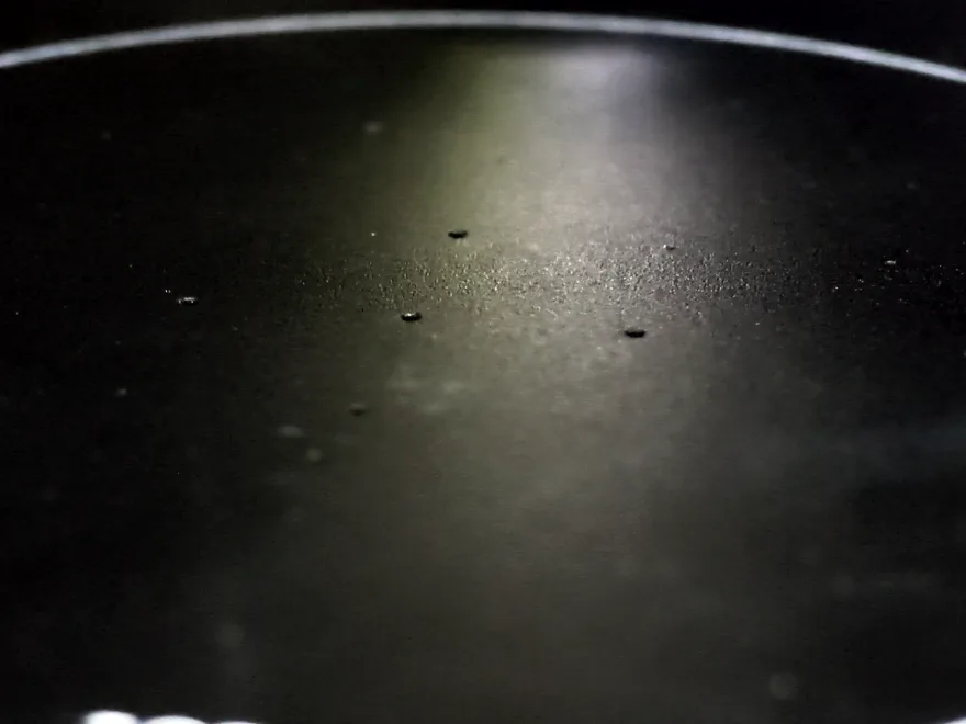 Close-up of the vacuum chuck's central region, showing the small vacuum holes clustered near the centre