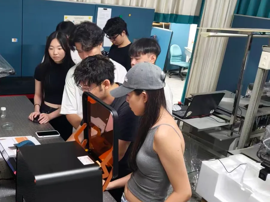 Students and faculty gathered around a NANYTE BEAM system during hands-on training at Chung Yuan Christian University